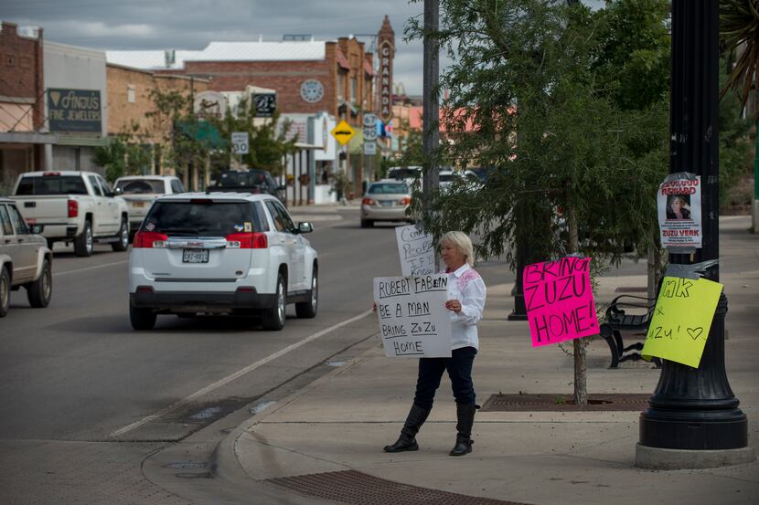 Alpine resident Glenda Westerman holds a sign pleading for Zuzu Verk's boyfriend to help...