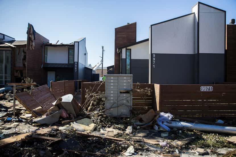 Debris stacked up outside the tornado-damaged Southwind Apartments on Wednesday, October 23,...