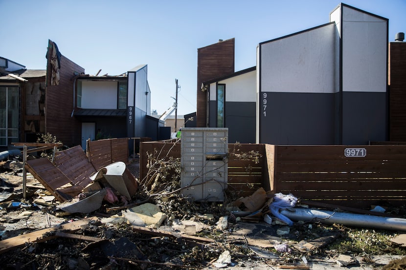 Debris stacked up outside the tornado-damaged Southwind Apartments on Wednesday, October 23,...