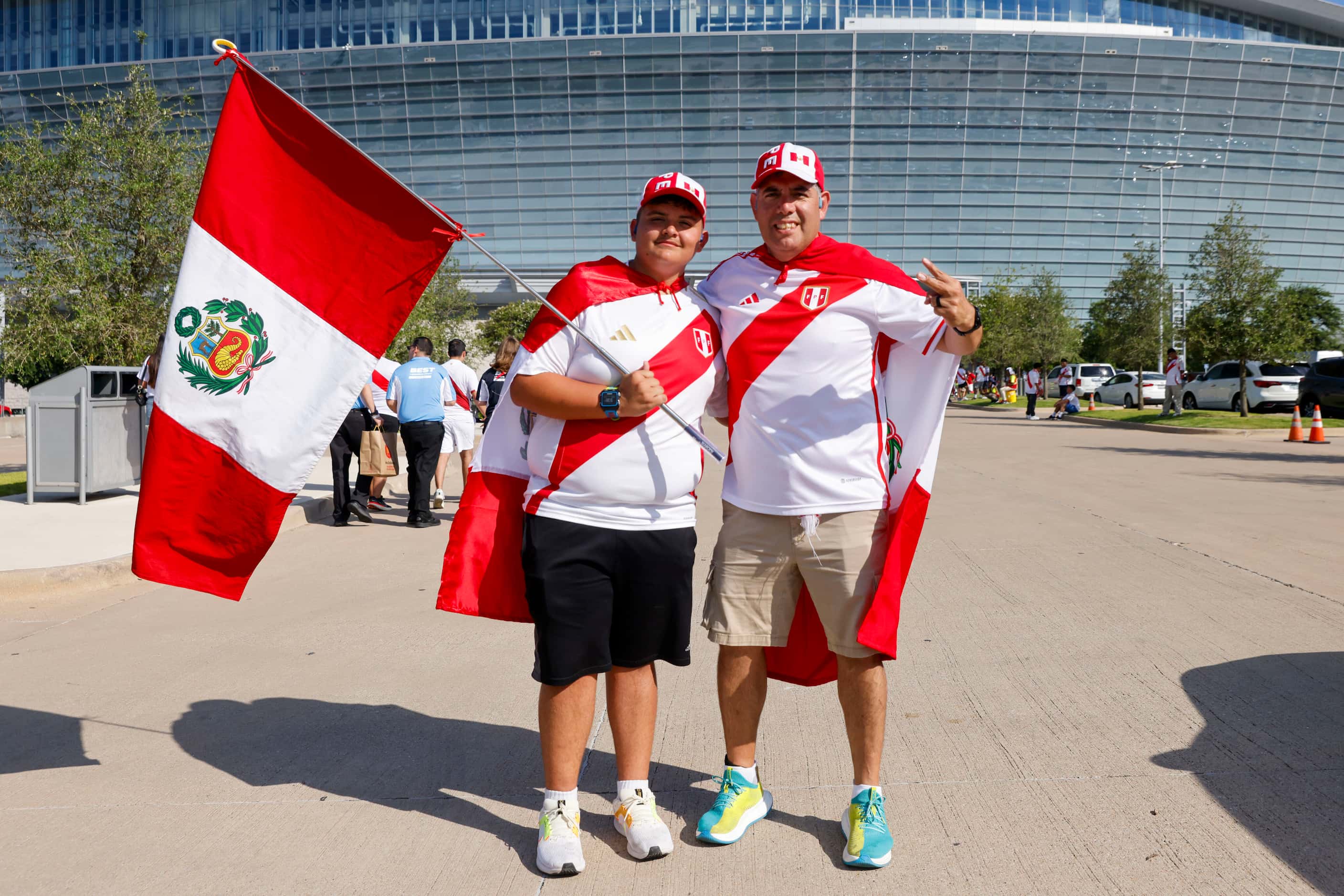 Christian Diaz (left) stands with his father Luis Diaz for a photo outside AT&T Stadium...
