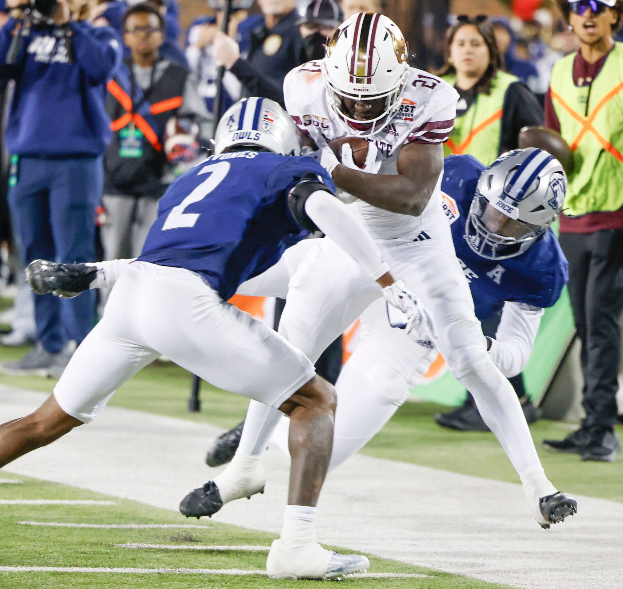 Rice cornerback Tre'shon Devones (2) and Rice linebacker DJ Arkansas (right) brings down...