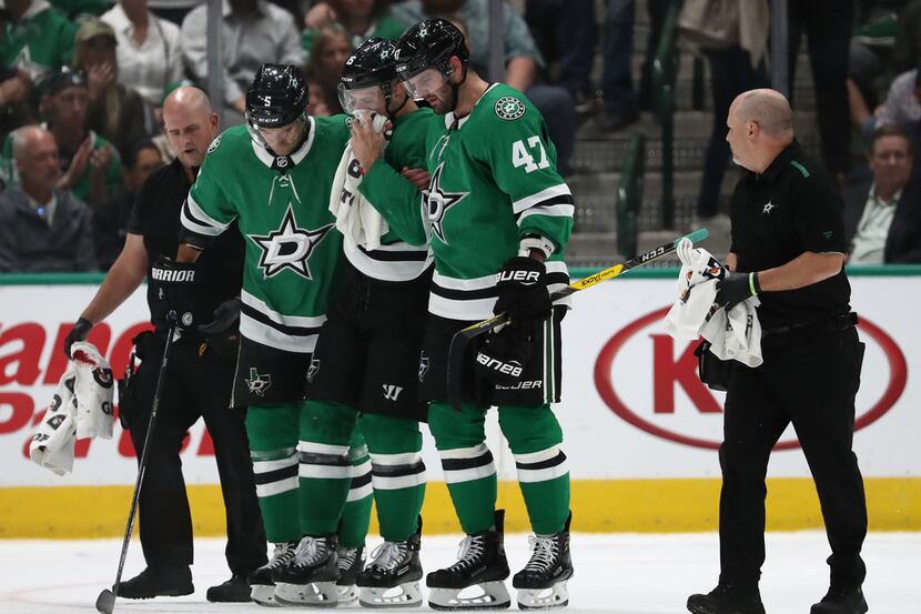 DALLAS, TEXAS - OCTOBER 03:   Blake Comeau #15 of the Dallas Stars is helped off the ice...