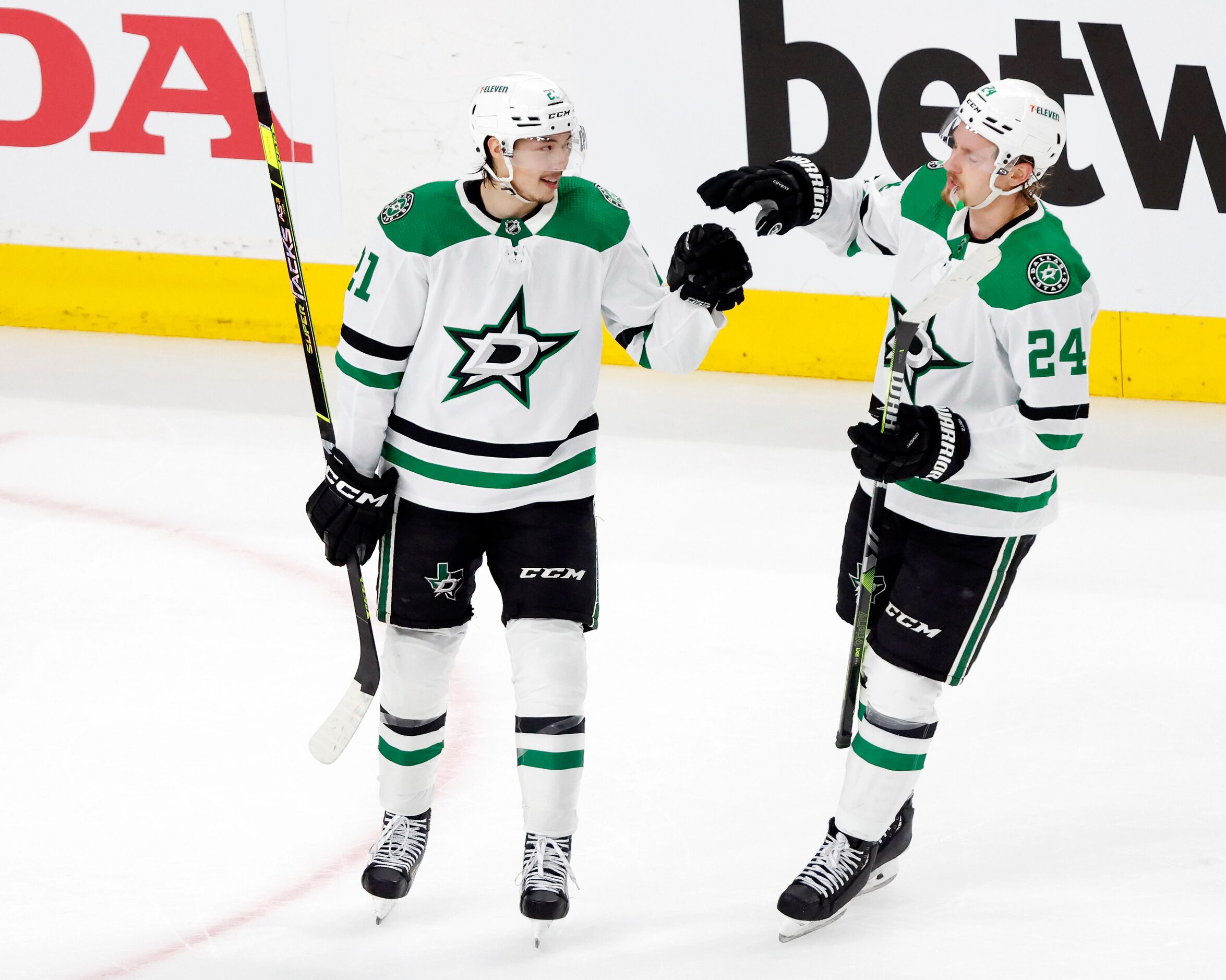 Dallas Stars left wing Jason Robertson (21) is congratulated by teammate Roope Hintz (24)...