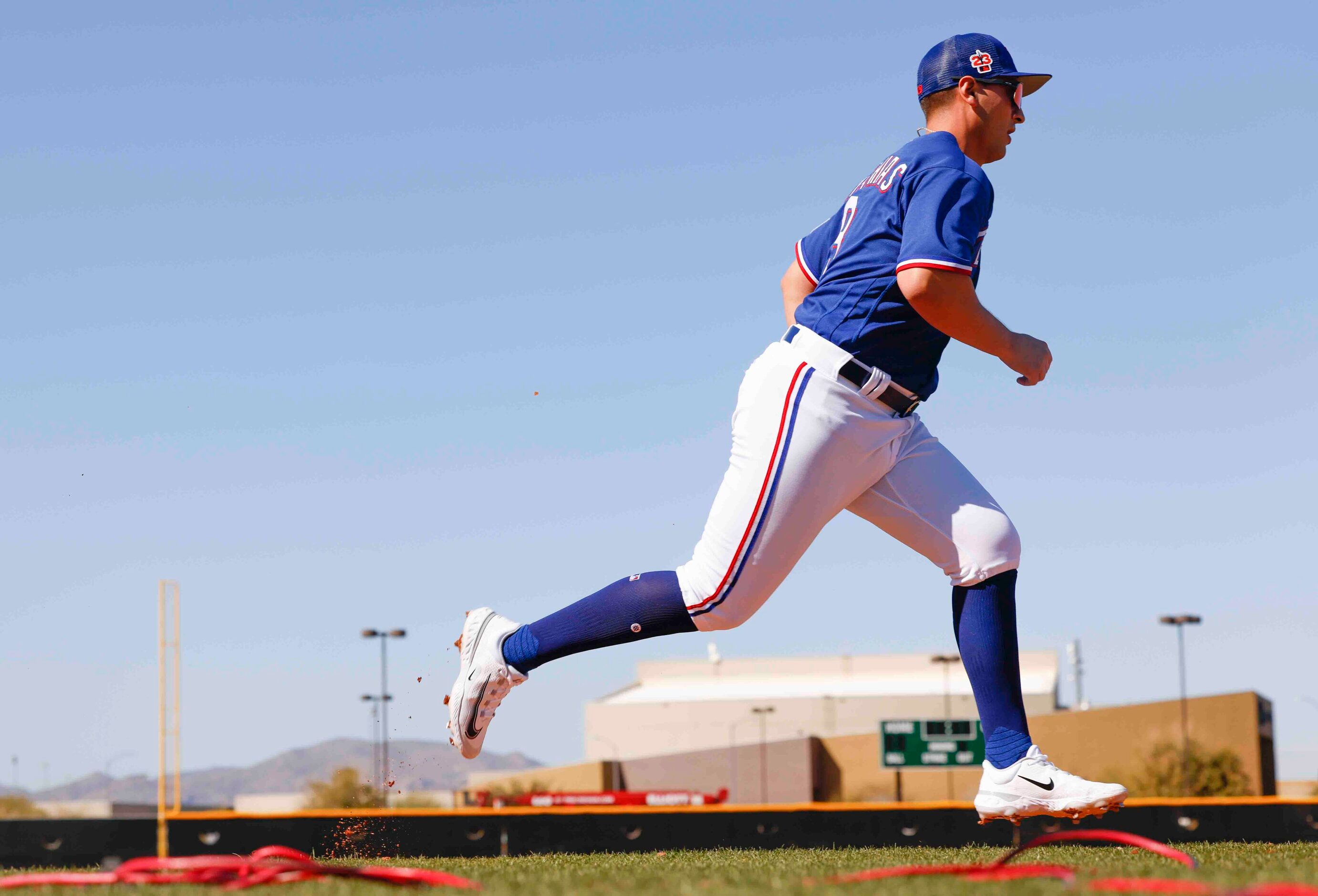 Texas Rangers infielder Mark Mathias runs during a drill at spring training workout at the...