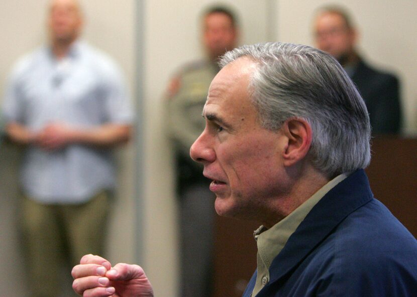 Gov. Greg Abbott talks with Secretary of Homeland Security John Kelly before a briefing on...