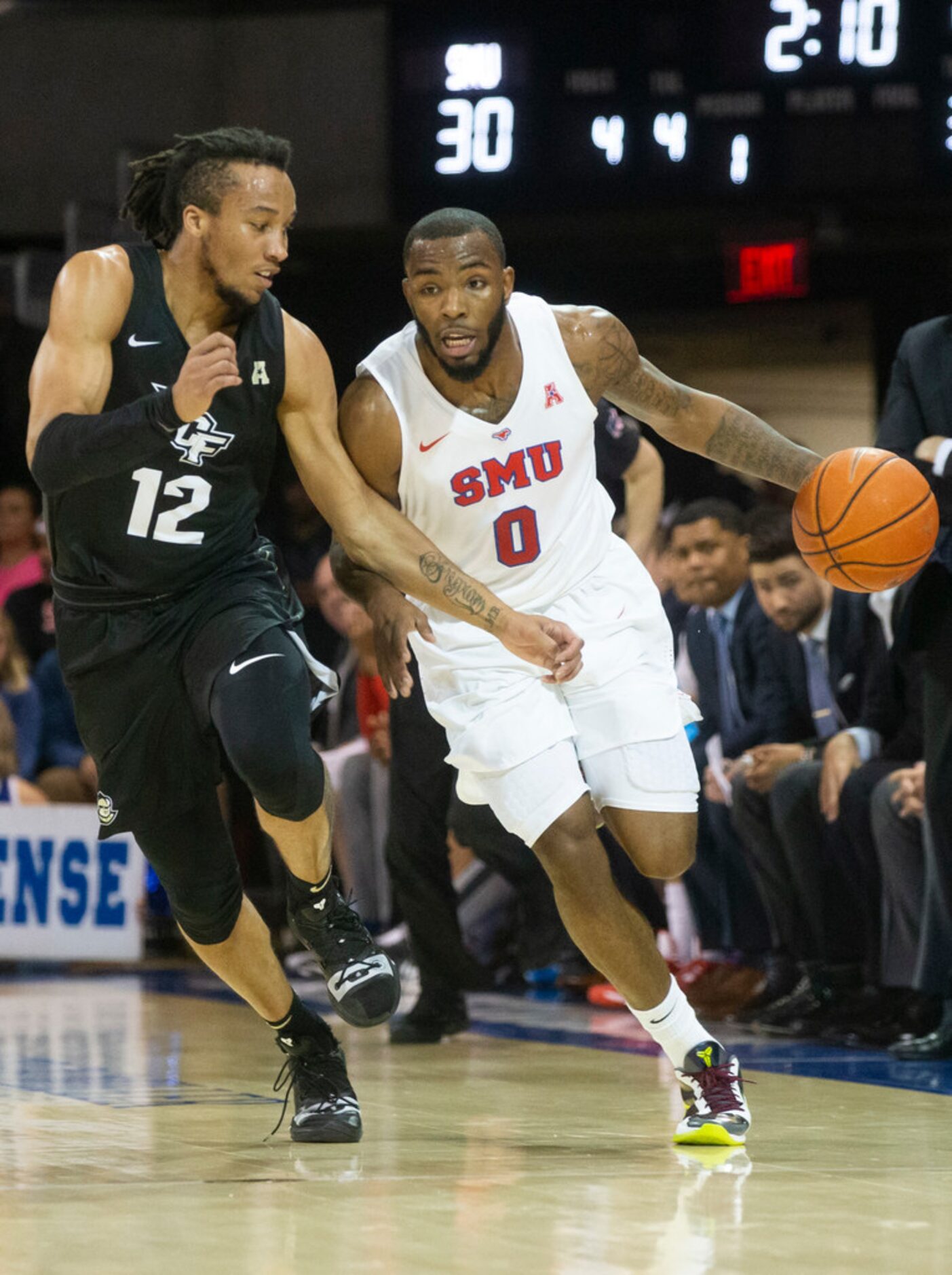 Southern Methodist Mustangs guard Tyson Jolly (0) drives the ball past UCF Knights guard...