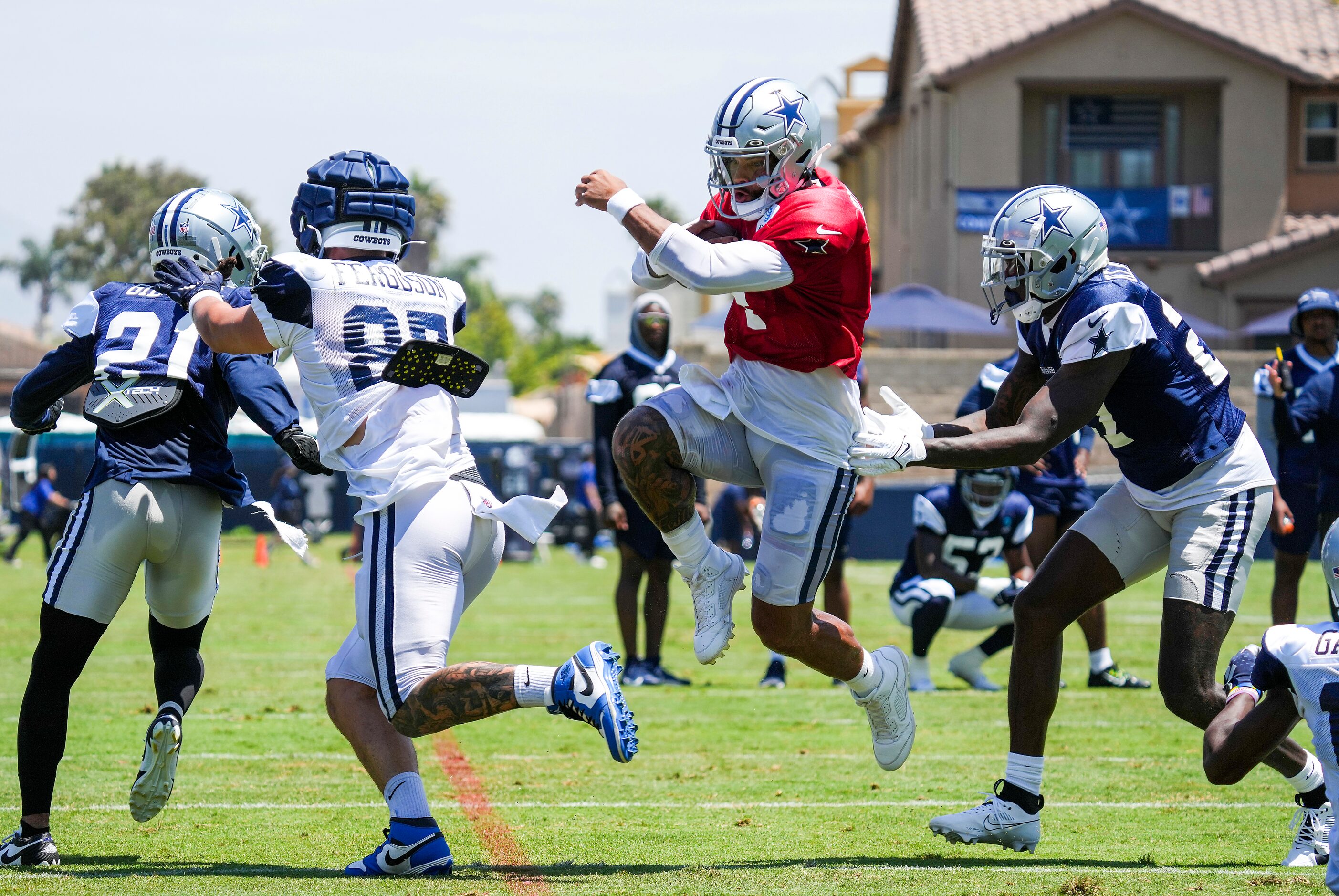 Dallas Cowboys quarterback Dak Prescott (4) gets a block from tight end Jake Ferguson (87)...