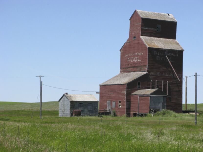 An aging grain elevator, one of a few hundred remaining from the thousands that once...