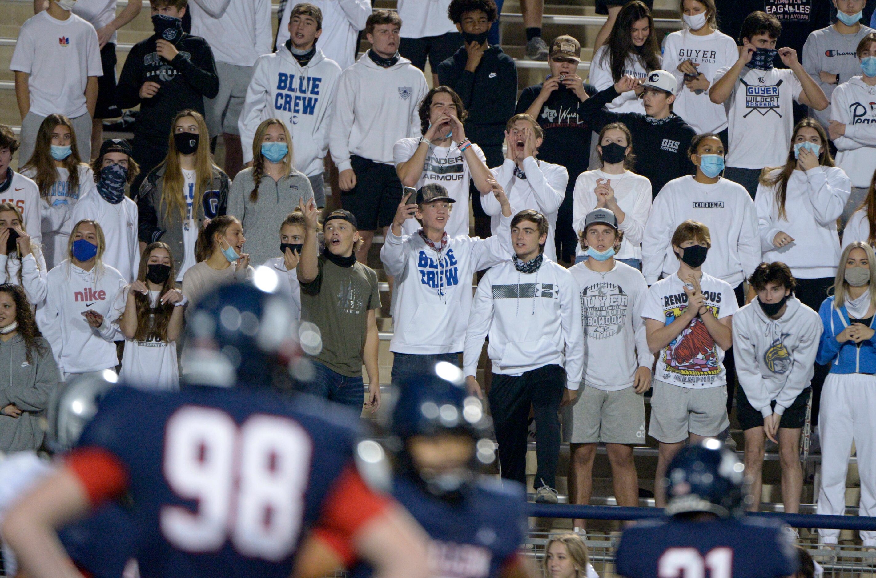 The Denton Guyer student section reacts to a call in the third quarter of a high school...