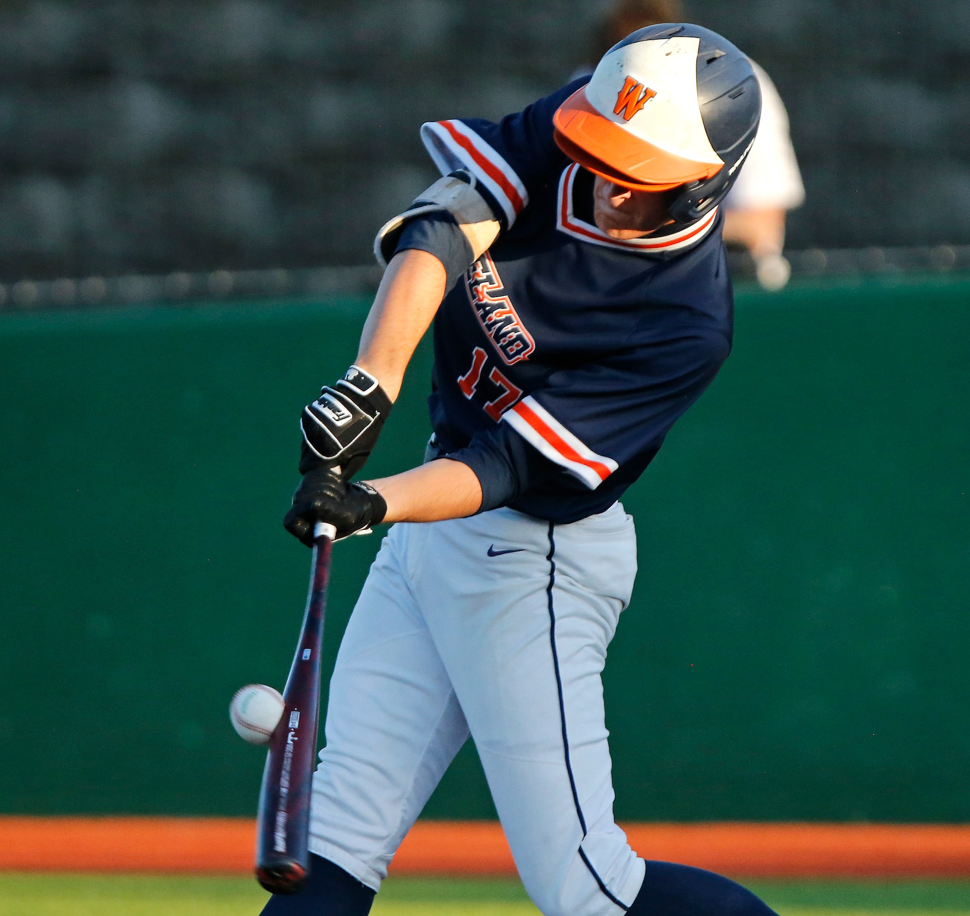 Wakeland High School third baseman Nicholas Miller (17) gets a hit in the second inning...