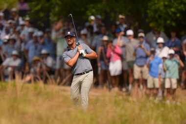 Bryson DeChambeau hits from the native area on the seventh hole during the final round of...