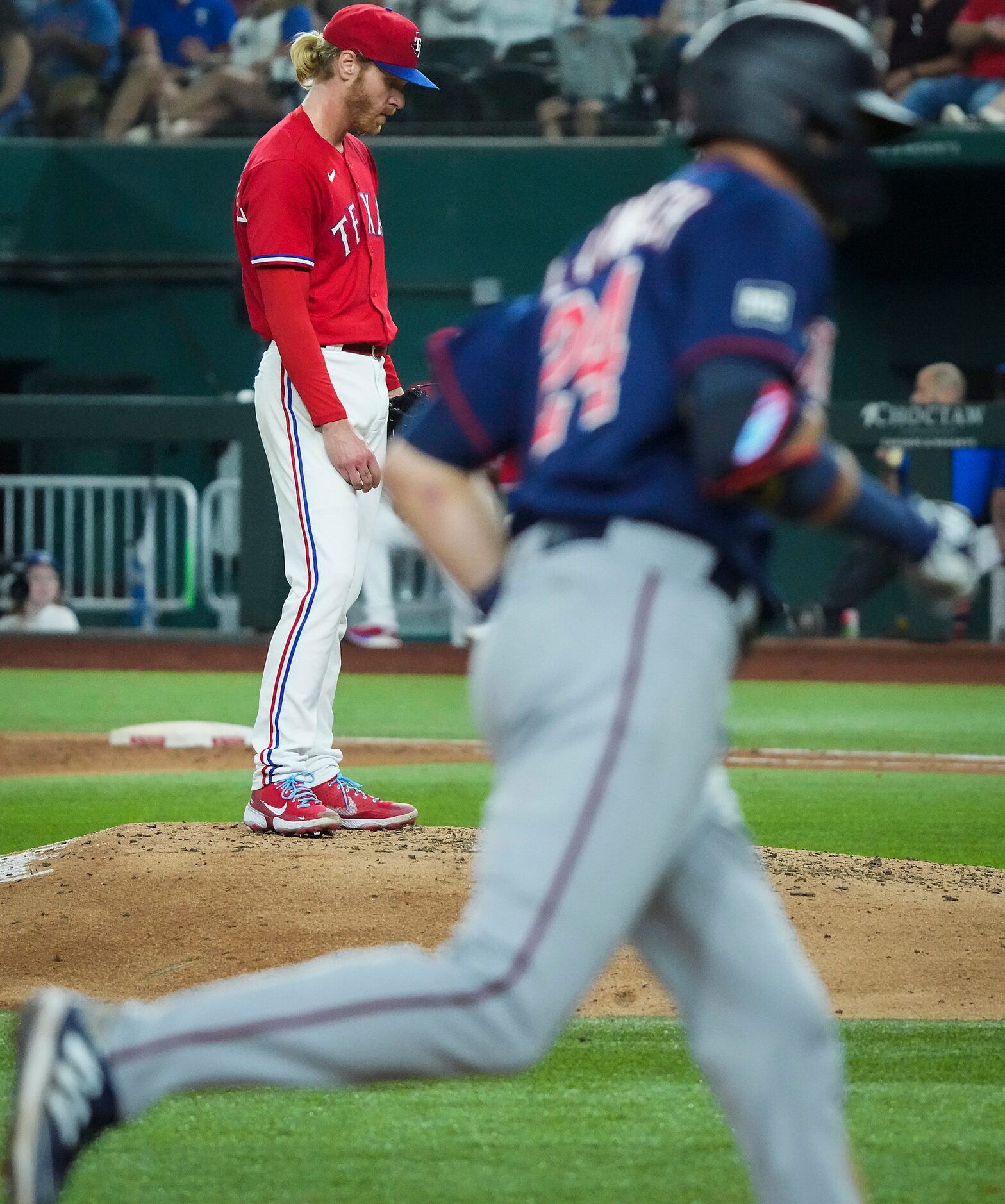 Texas Rangers starting pitcher Mike Foltynewicz looks down as Minnesota Twins left fielder...