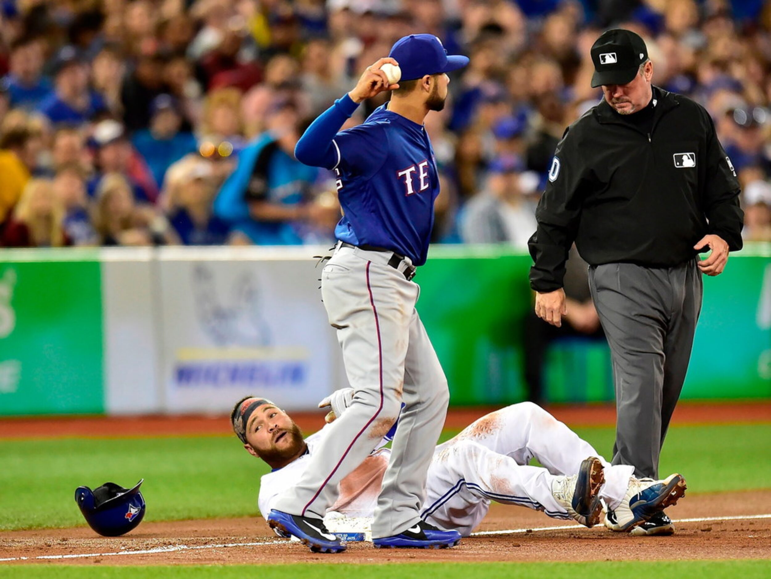 Toronto Blue Jays' Russell Martin sits on third base after being called out during the...