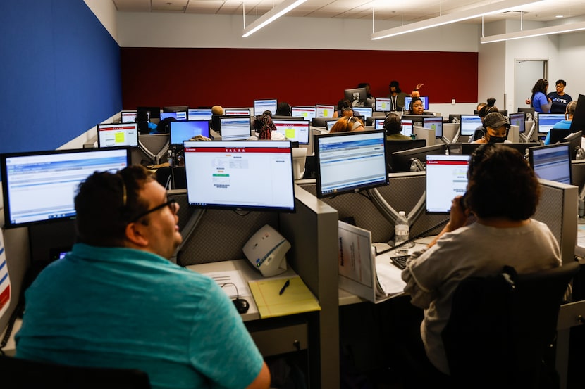 Phone operators work to monitor the midterm elections at the Dallas County Election...