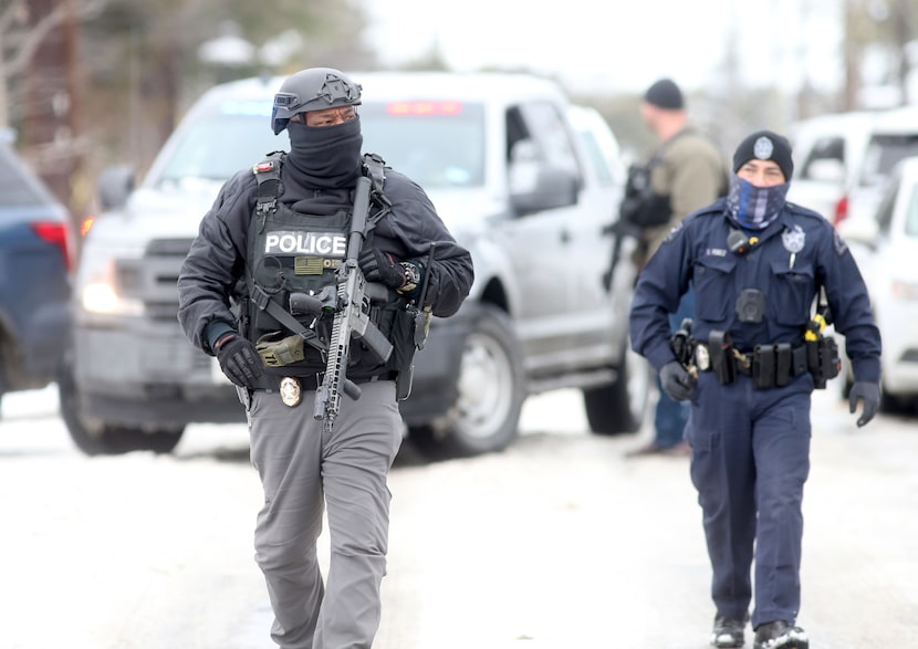 Dallas police officers secure the area at N. Henderson Ave. and Bonita Ave., after a...