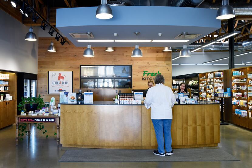 Chef Joanne Bondy, right, owner of Stocks & Bondy, speaks to employees from Sundrops...