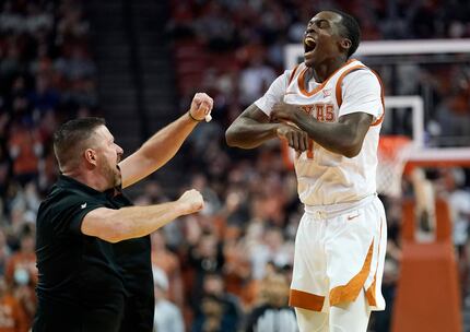 Texas head coach Chris Beard, left, celebrates with guard Andrew Jones (1) during the second...
