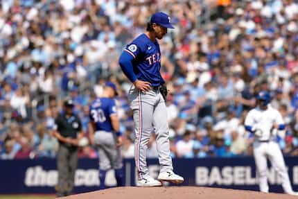 Texas Rangers pitcher Michael Lorenzen reacts as he stands on the mound as he works against...