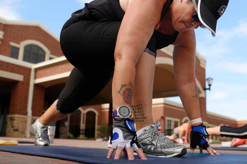 Rhonda-Lee Foulds stretches at the end of a Camp Gladiator workout held in front of Cox...