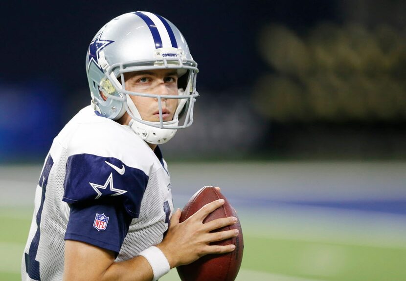 Dallas Cowboys quarterback Kellen Moore (17) drops back to pass in a drill at practice...