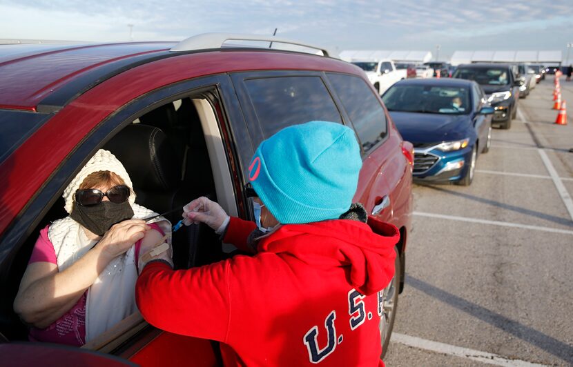 Donna Bergman of Flower Mound receives a COVID-19 vaccination from Penny Mayo at a...