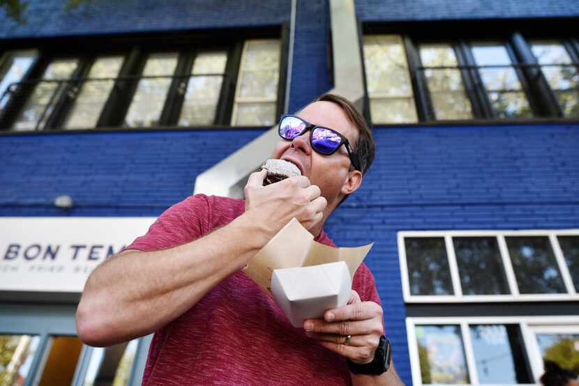 Justin Wood, 36, bites into a free sample chocolate beignet from Le Bon Temps in Dallas.