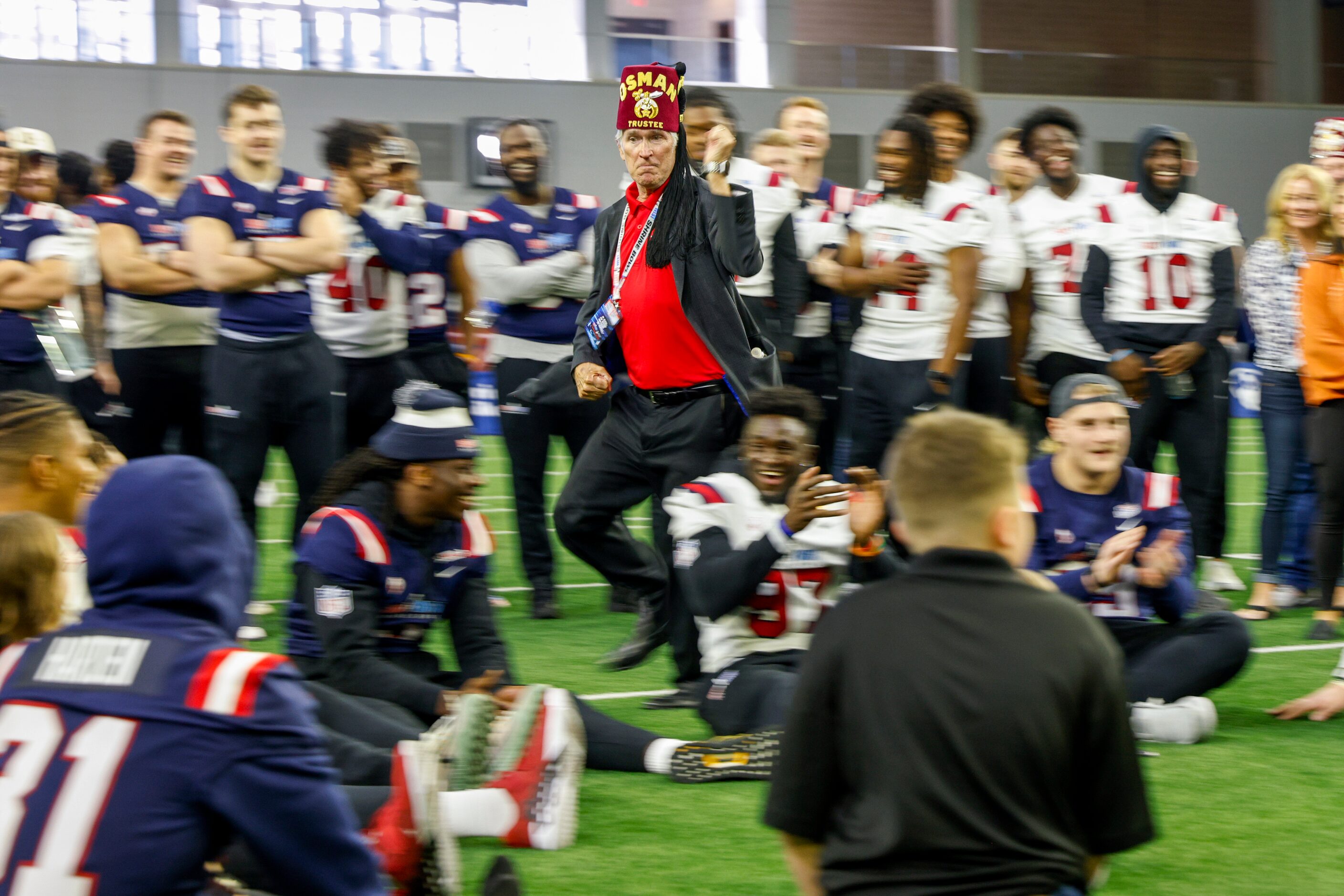 Shriners Children’s hospital trustee Ken Guidera runs as he plays duck duck goose with...