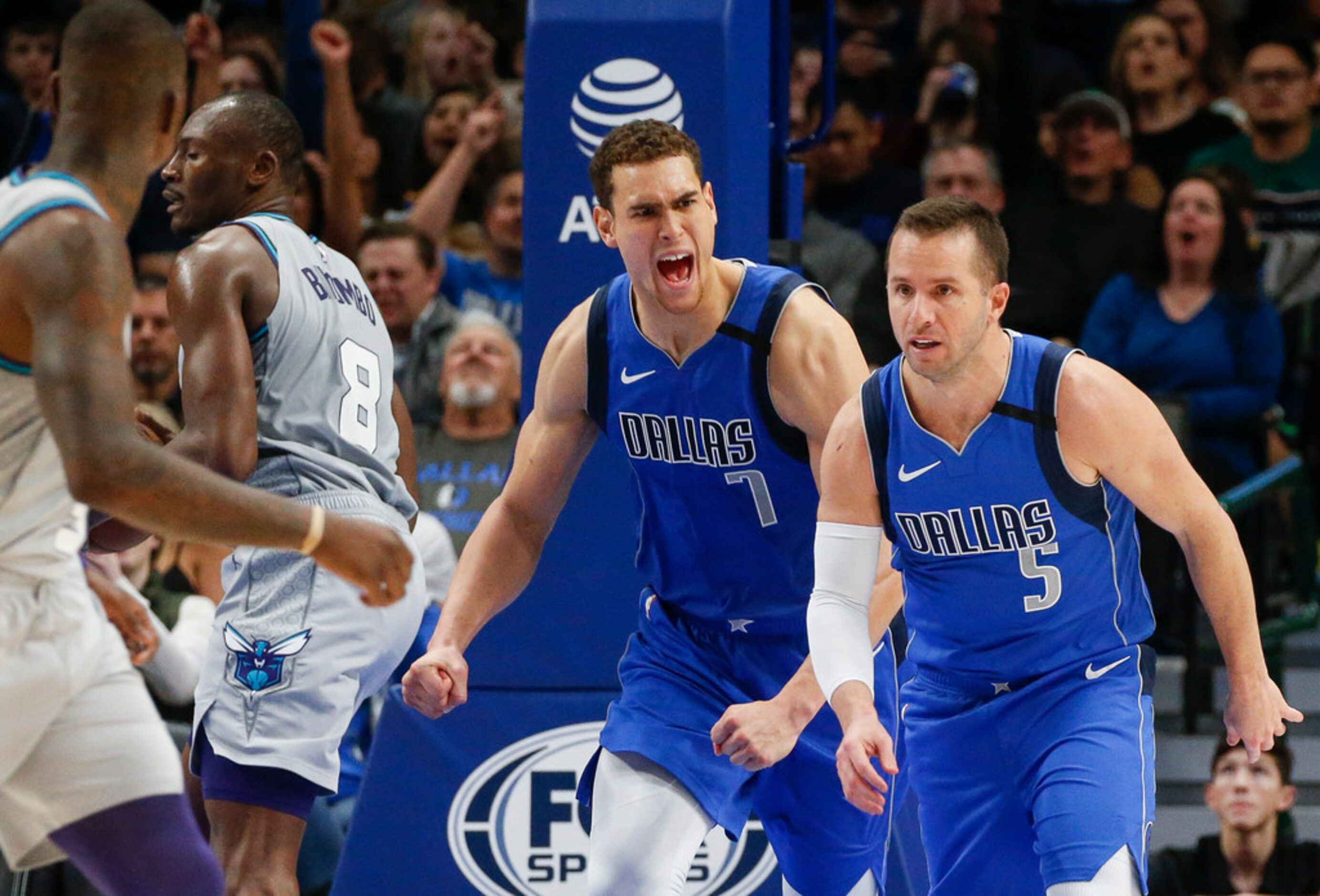 Dallas Mavericks guard J.J. Barea (5) and forward Dwight Powell (7) celebrate scoring during...