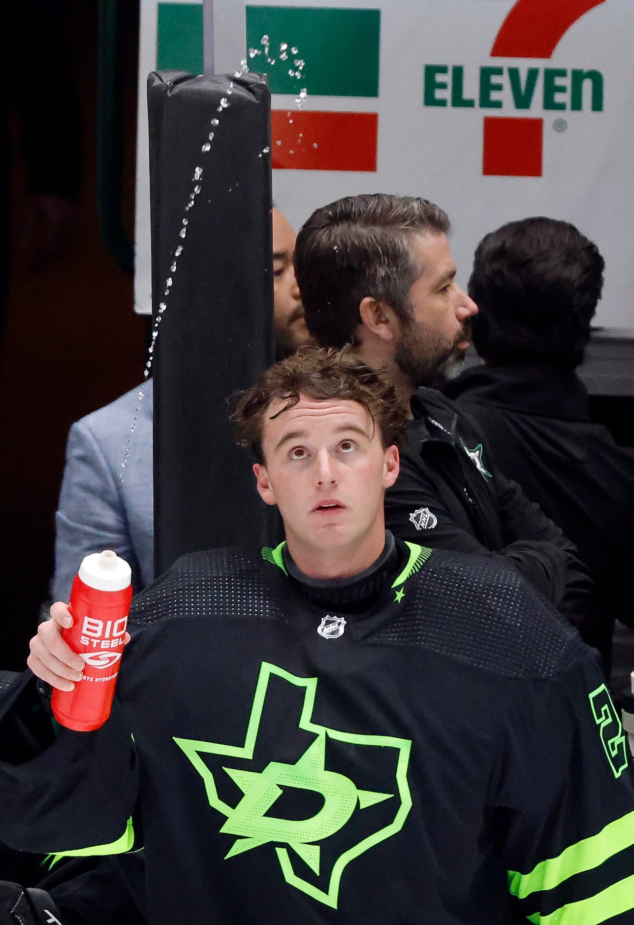 Dallas Stars goaltender Jake Oettinger (29) squirts water onto the ice during a timeout...