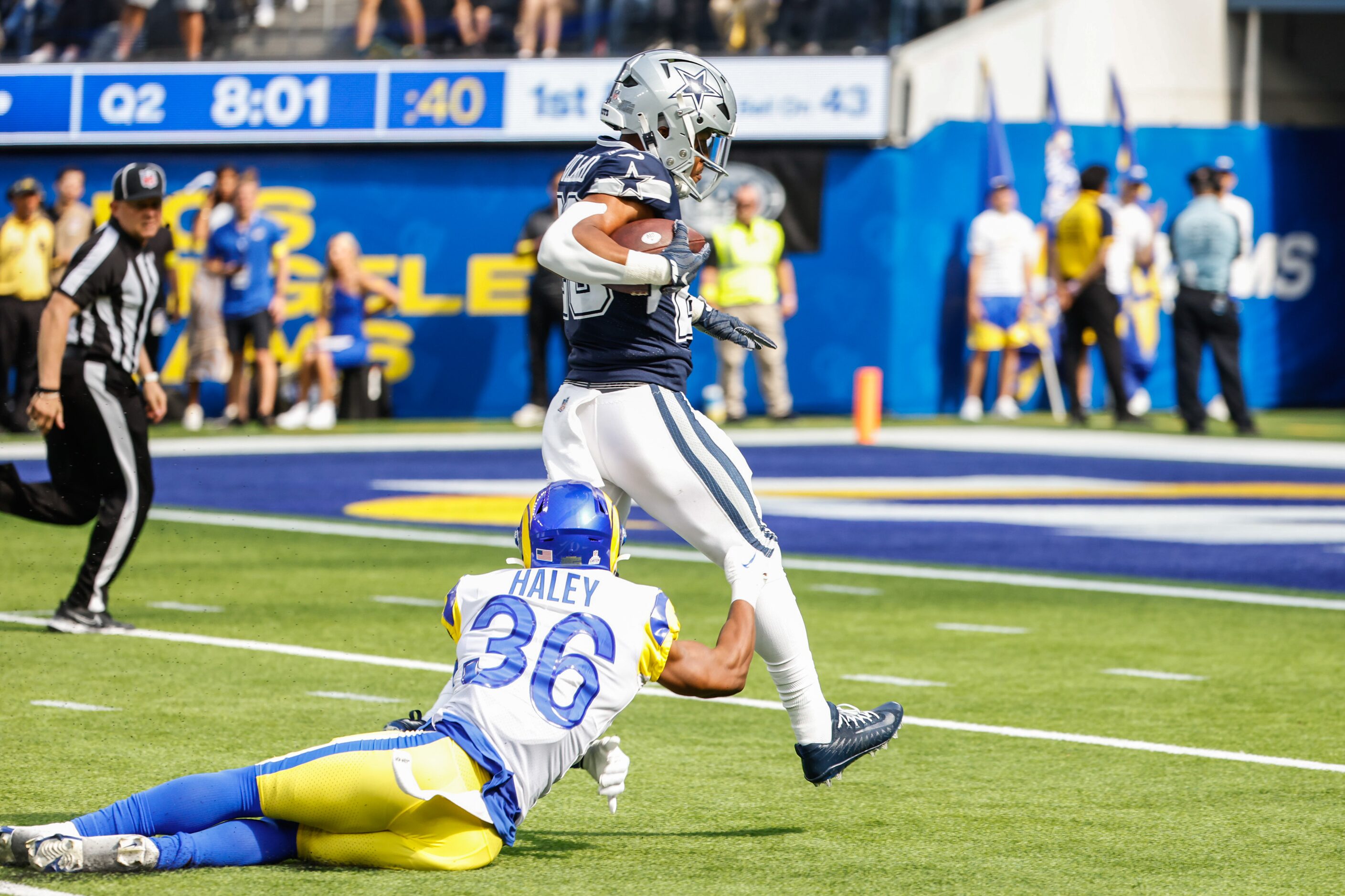 Dallas Cowboys running back Tony Pollard (20) gets past Los Angeles Rams safety Nick Scott...