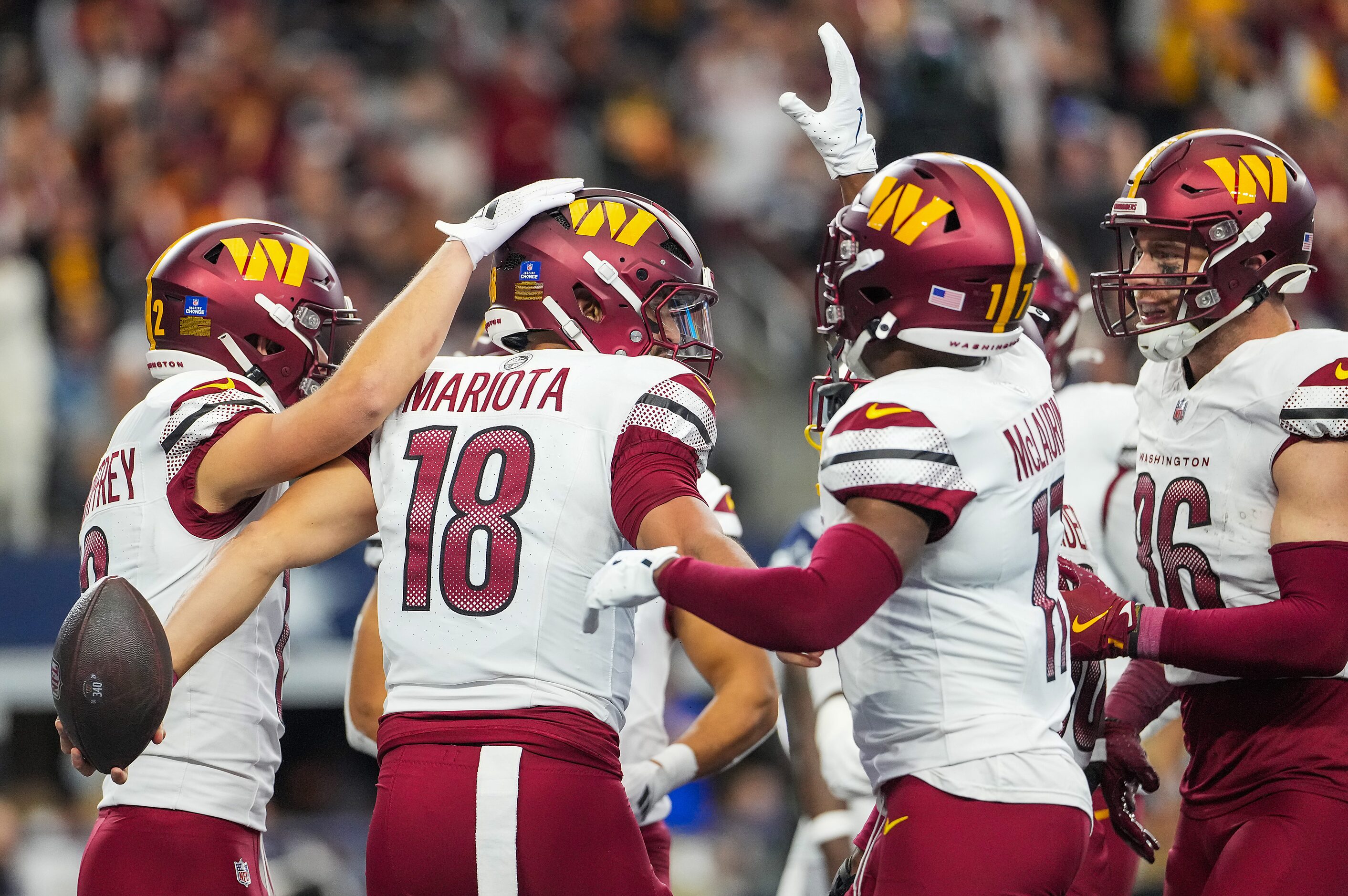 Washington Commanders quarterback Marcus Mariota (18) celebrates after scoring on a short...