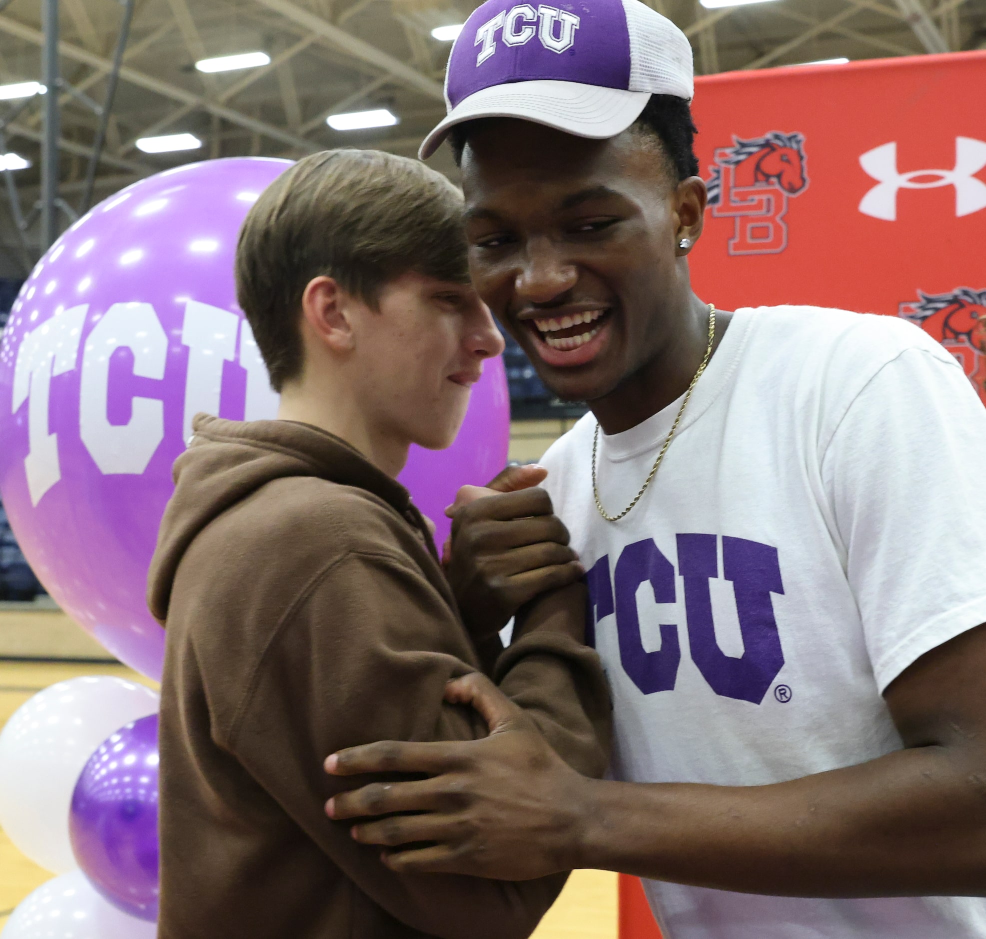 Blake Muschalek and Isaiah Manning shake hands after Manning commits to play basketball at...