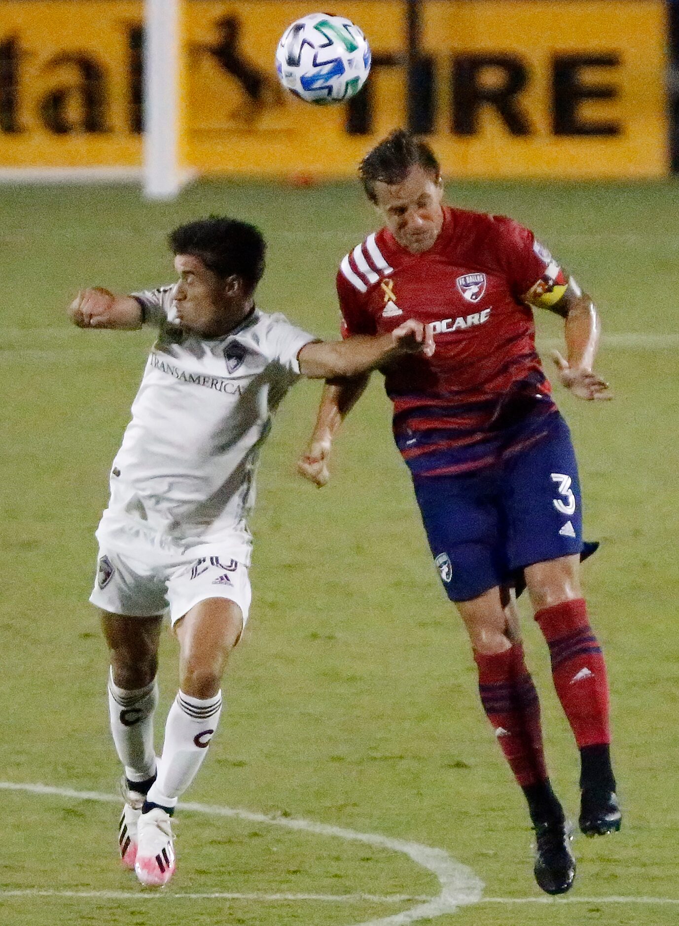 Colorado Rapids forward Nicolas Mezquida (20) and FC Dallas defender Reto Ziegler (3) go up...