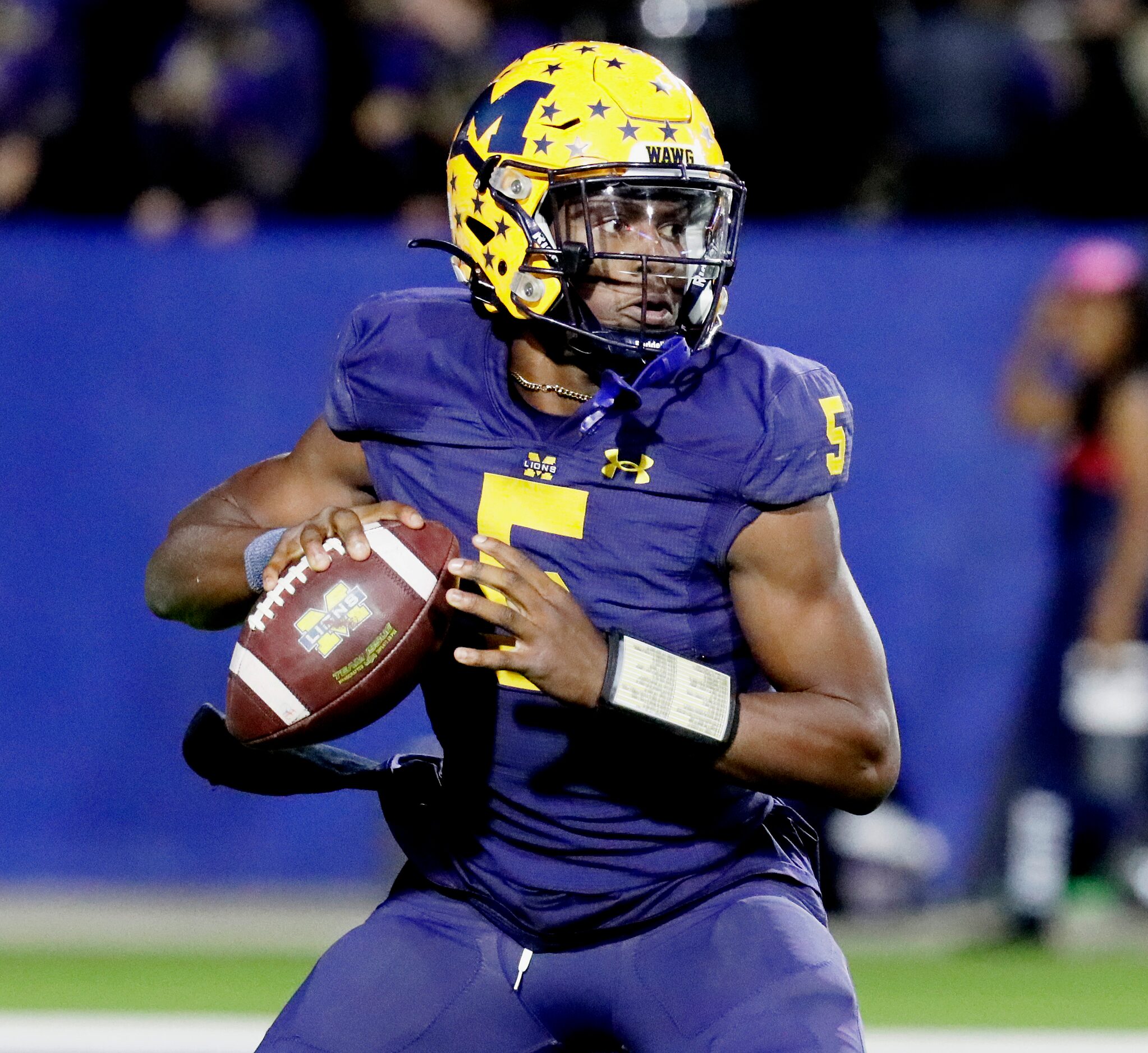 McKinney High School quarterback Godspower Nwawuihe (5) looks to pass before running the...