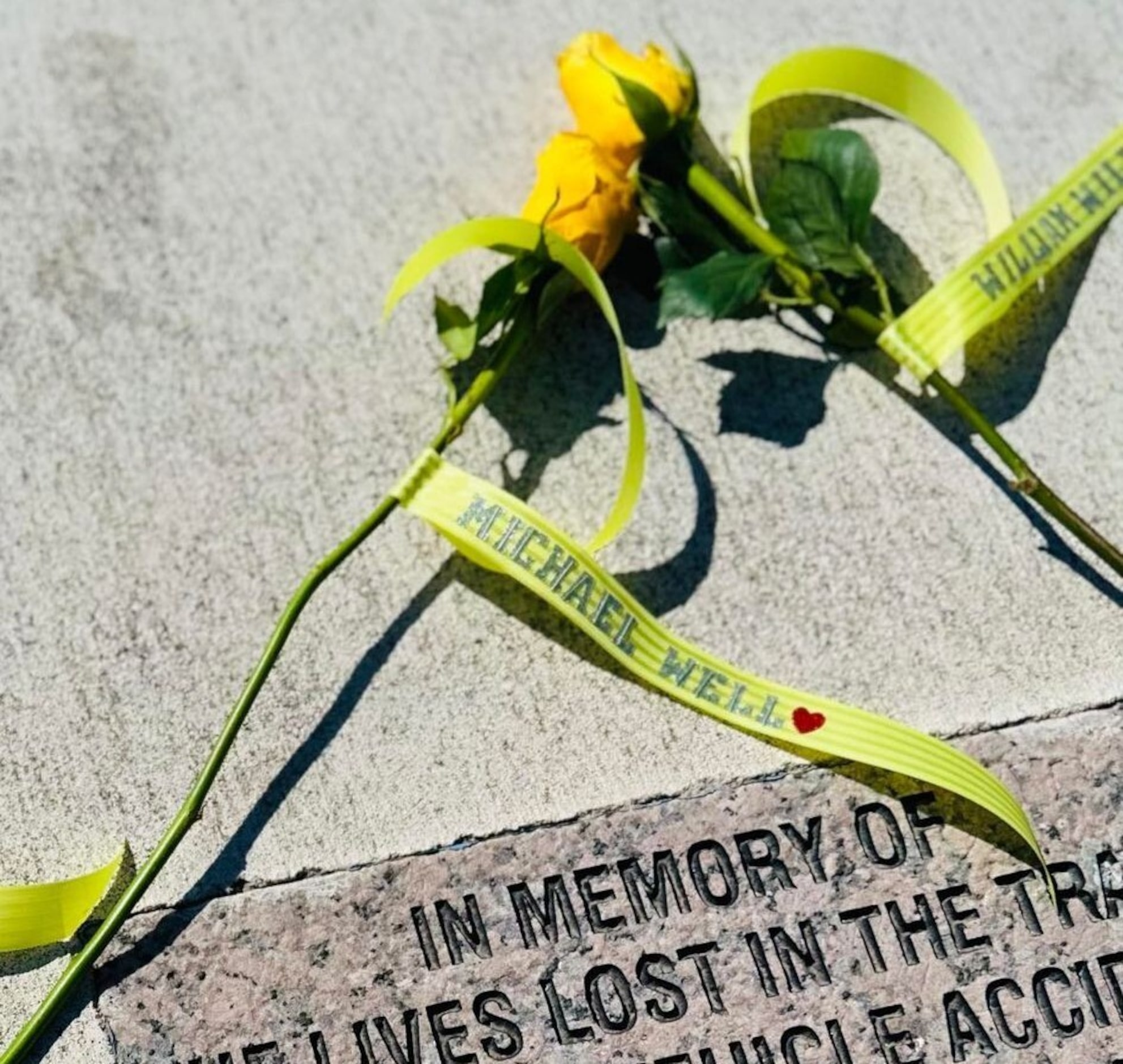 The name of Michael Wells is attached to a flower near the memorial for a fatal crash Feb....