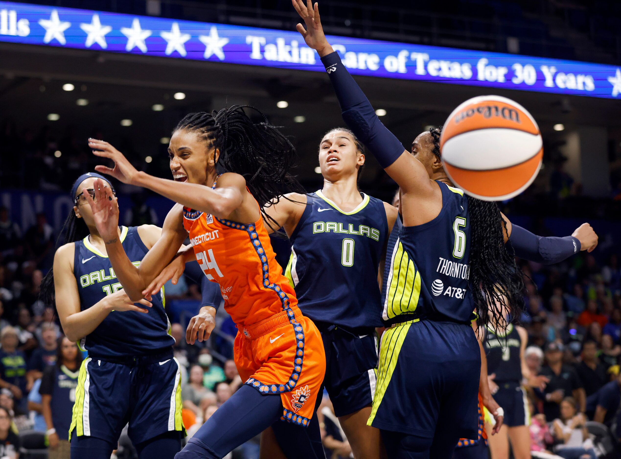 Dallas Wings forward Satou Sabally (0) swats away a shot by Connecticut Sun forward DeWanna...