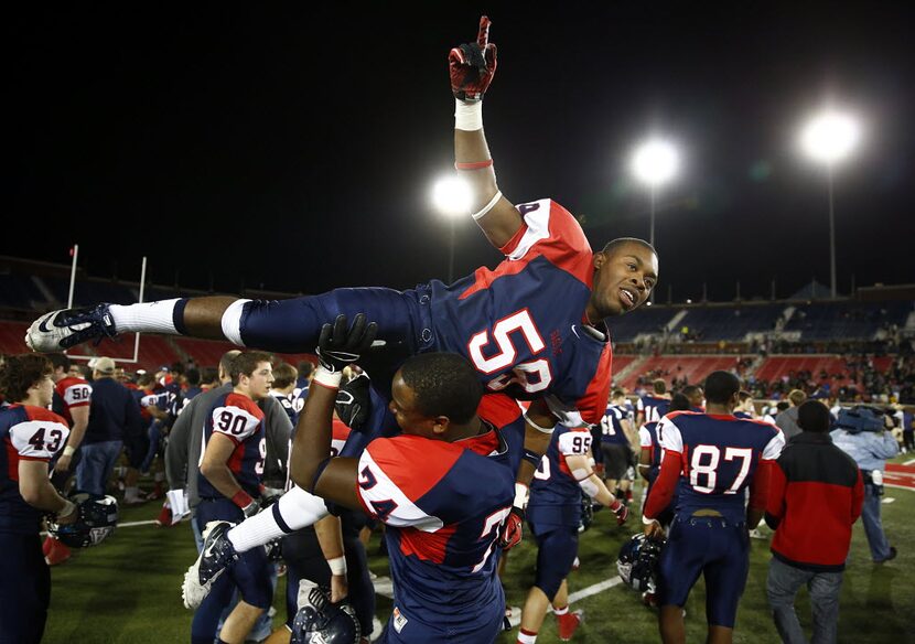 Allen's Cari Freeman (59) and Nnamdi Onwuzurike (74) celebrate their win over DeSotoin the...