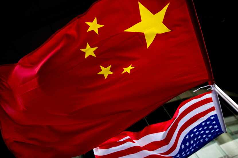 File photo of U.S. and Chinese national flags are hung outside a hotel during the U.S....