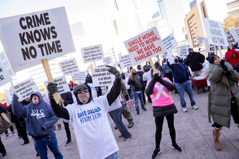 People protest in January 2022 outside of Dallas City Hall ahead of a vote to restrict the...