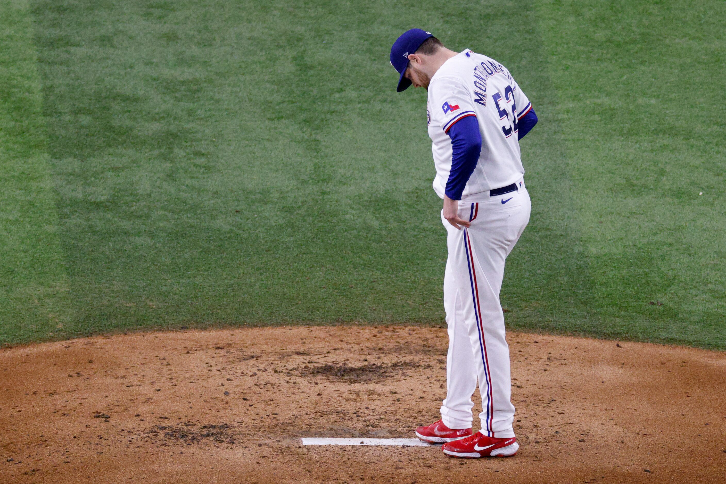 Texas Rangers starting pitcher Jordan Montgomery (52) reacts after giving up a home run to...