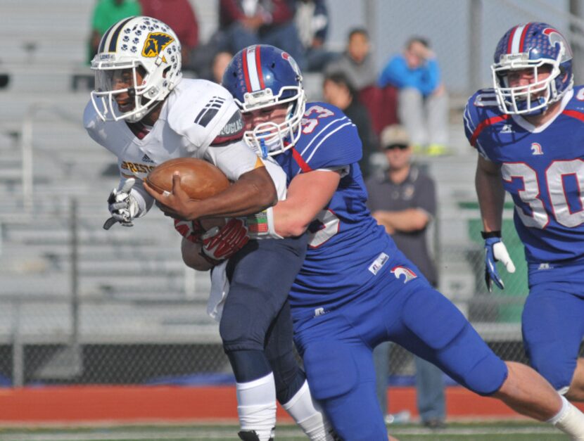 TCA - Addison senior Brock Bacon (33) stops the run of Prestonwood junior Twayne Blackwell...