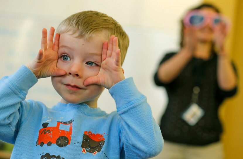 
Grady Boyd, 2, sings along with librarian Jenna Yoder during Boogie Woogie Books at White...