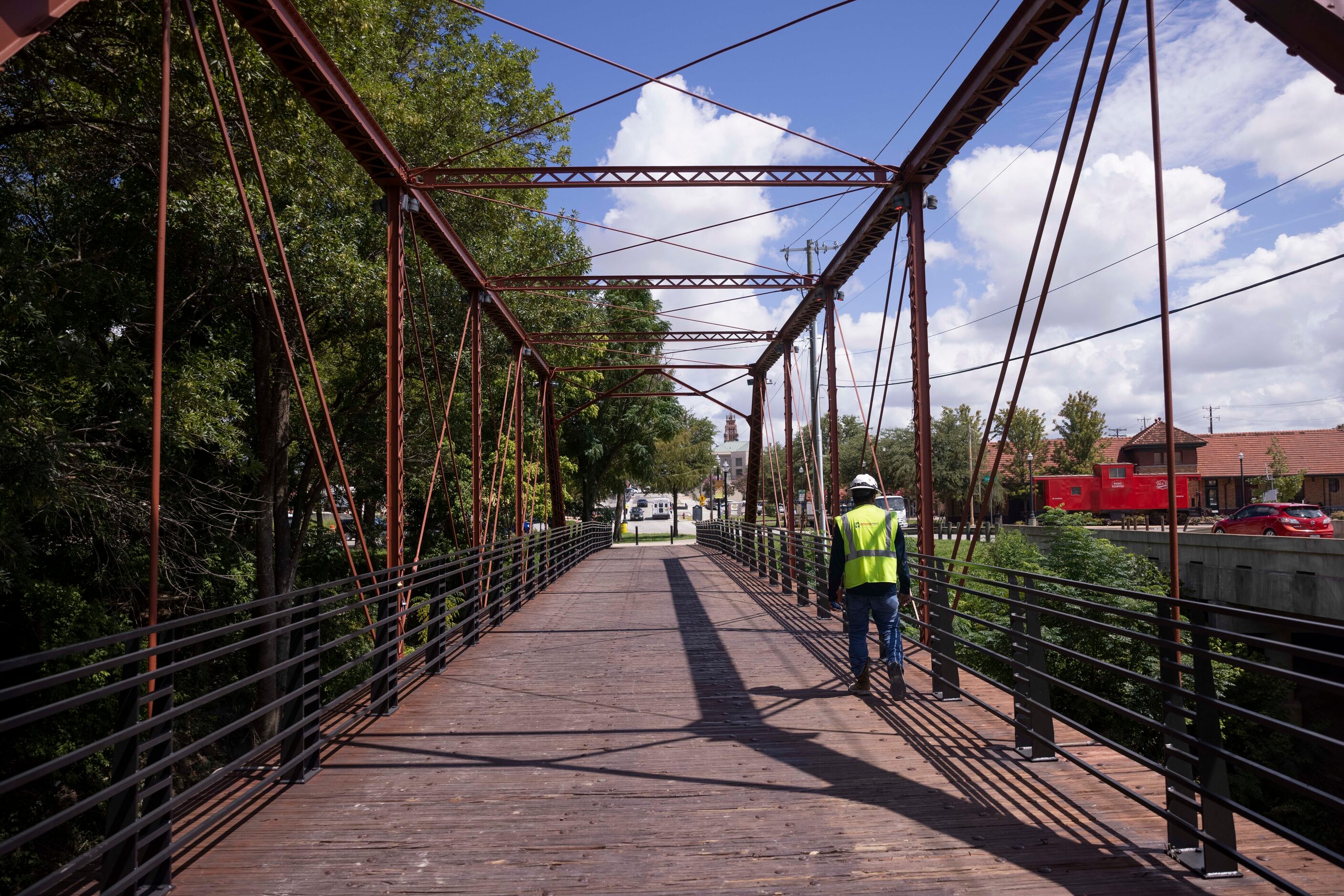 A construction worker walks across the historic Rogers Street Bridge on Aug. 29 in Waxahachie.