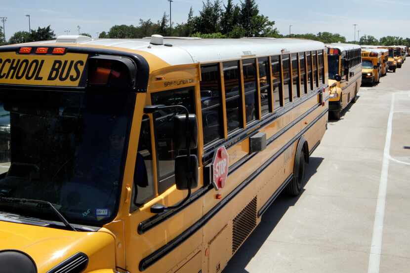 DISD school bus drivers leave Kleberg Service Center to pick up students in Dallas on...