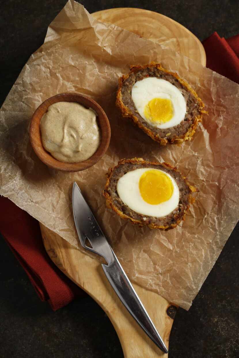 Baked Scotch Eggs with Crushed Cornflakes. Credits: Olive wood serving board from West Elm,...