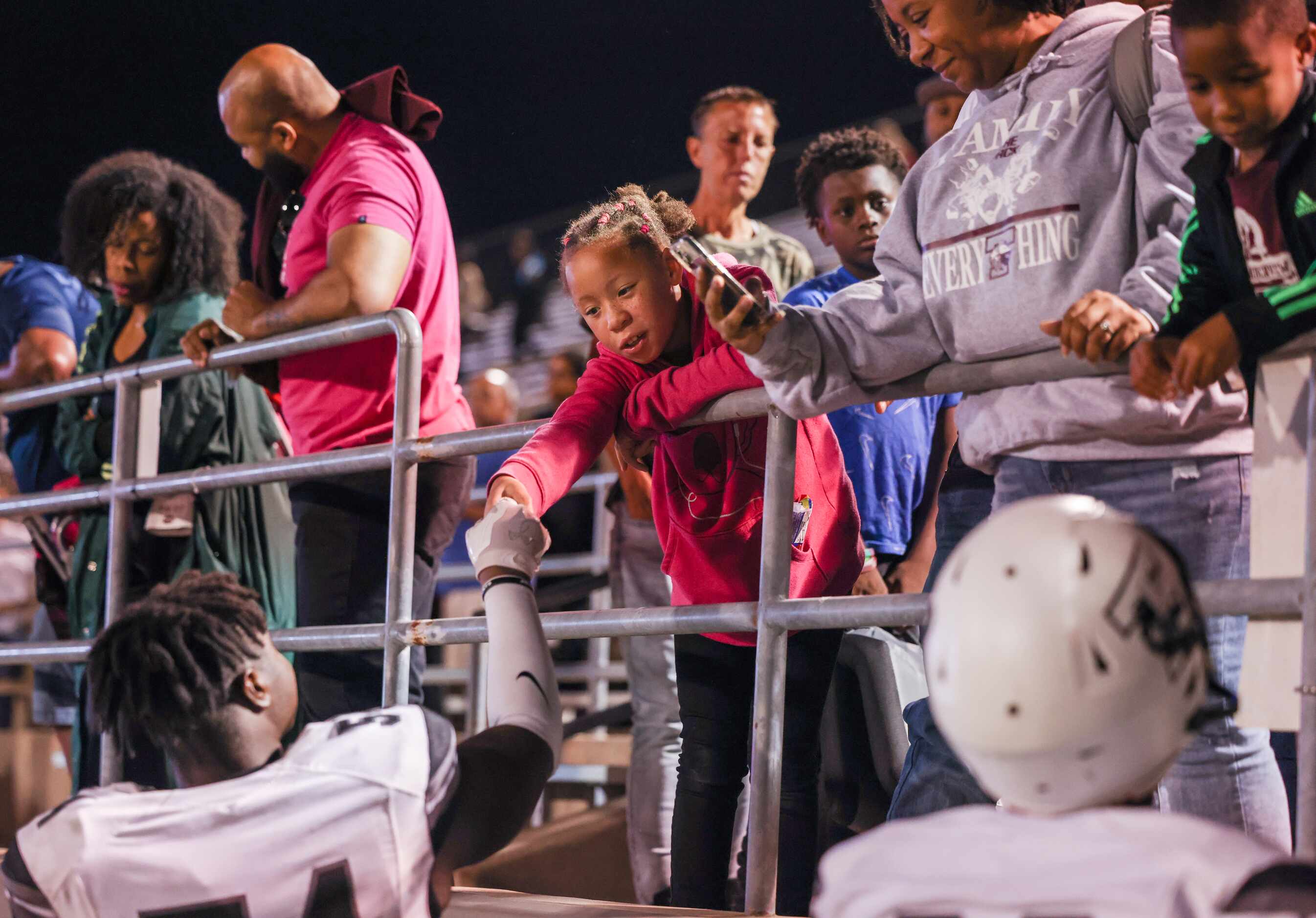 Mansfield Timberview defensive line Darren Walker (54) is greeted in the stands after...