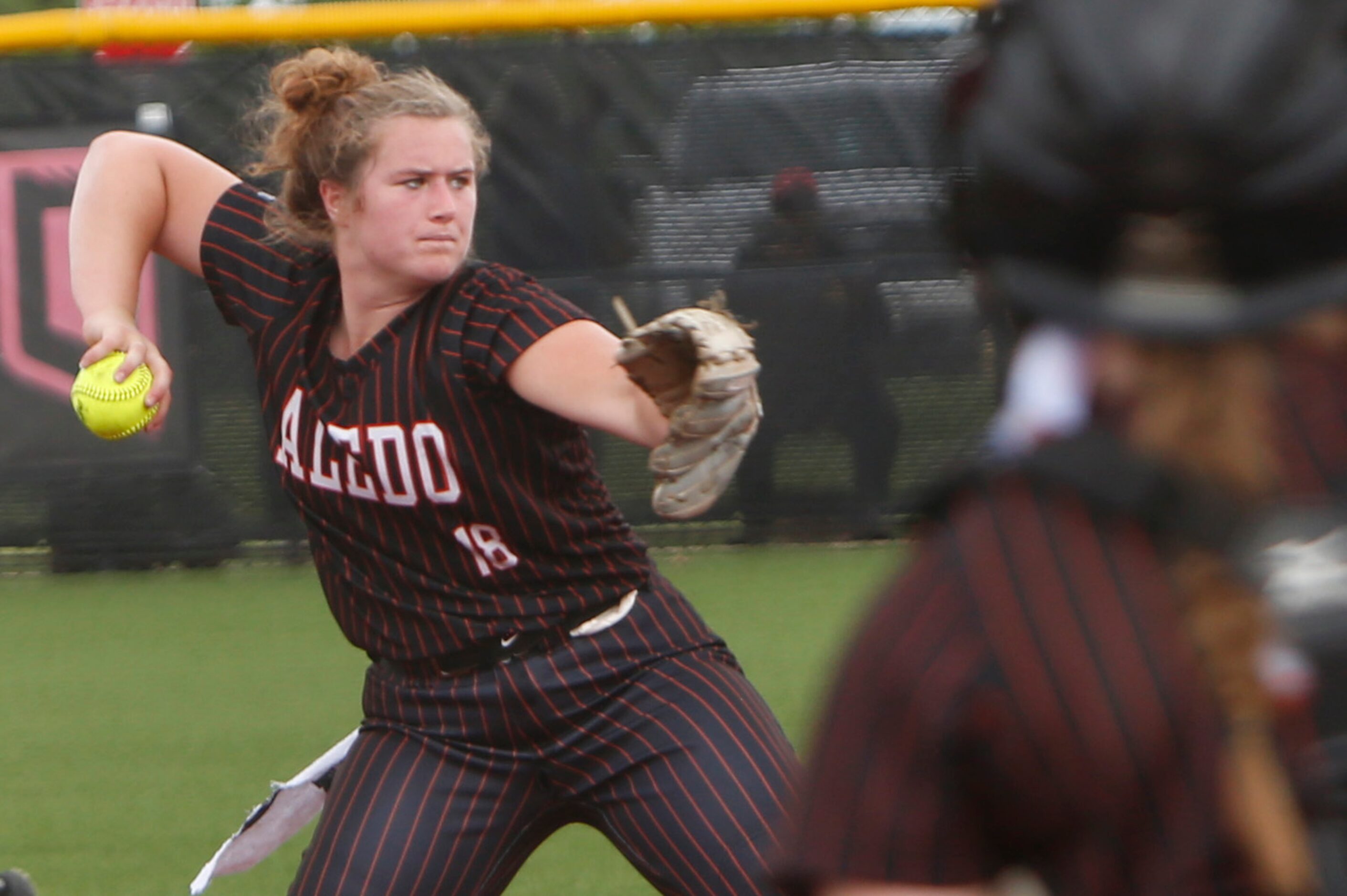 Aledo 3rd baseman Madysen Buntwell (18) looks a baserunner back at 3rd base before firing to...