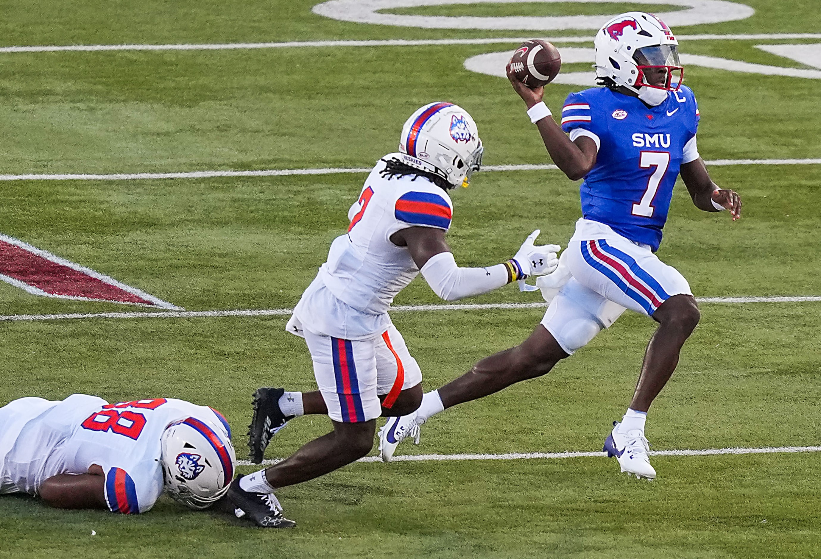 SMU quarterback Kevin Jennings (7) scrambles away from the Houston Christian defense during...