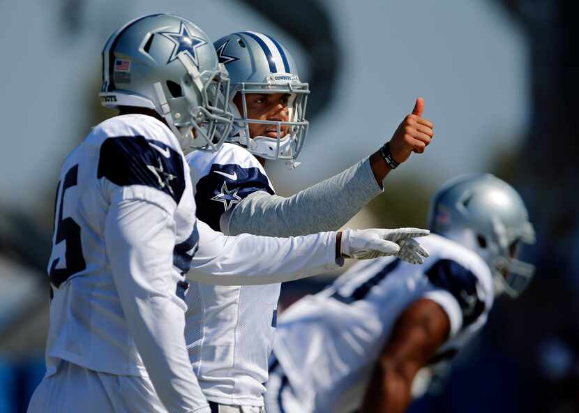 Dallas Cowboys quarterback Jameill Showers (7) gives a thumbs up to his receiver during...