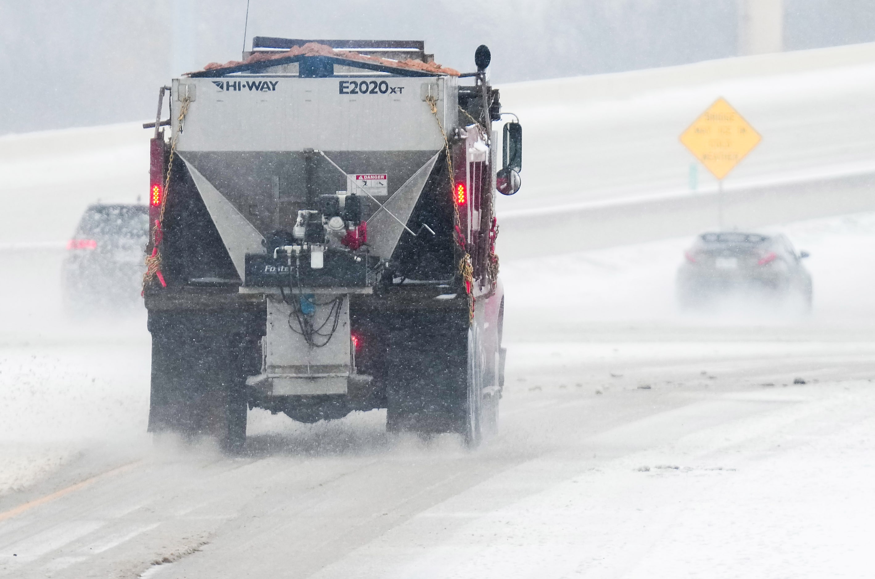 Crews treat the Bush Turnpike near Alma as snow falls on Thursday, Jan. 9, 2025, in...